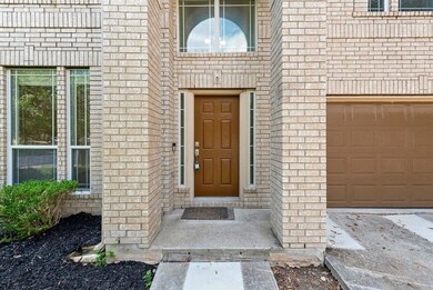 View of exterior entry featuring brick siding