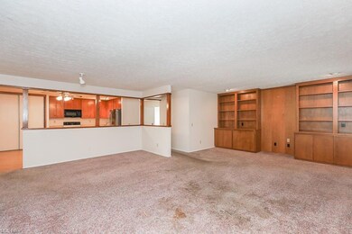 Living room featuring light carpet and a textured 