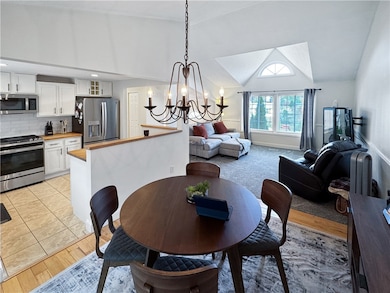 The dining room features a wood floor and is open