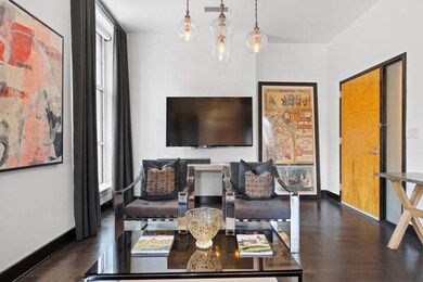 Living room with dark wood-style floors and baseboards