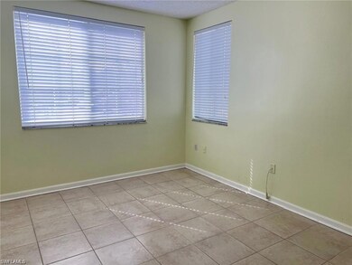 Unfurnished room featuring light tile patterned floors, plenty of natural light, and a textured ceiling