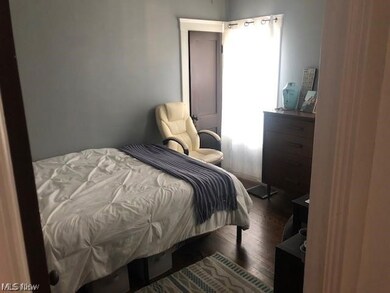 Bedroom featuring dark wood-type flooring