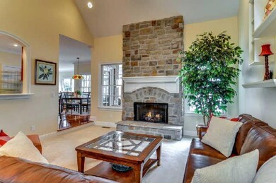 Formal living room with gas fireplace and stone hearth