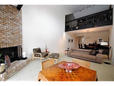 Living room with fireplace and lofted ceiling.