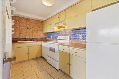 Kitchen has opening to living-dining area