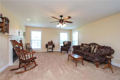Living room with fireplace and ceiling fan