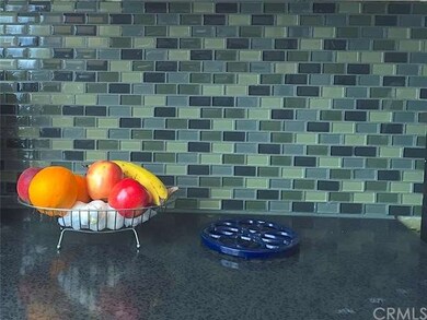 Glass Tiled Backsplash.  Composite Granite Counter