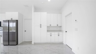 Kitchen featuring light countertops, marble finish