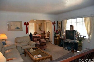 Living room looking towards front of house and din