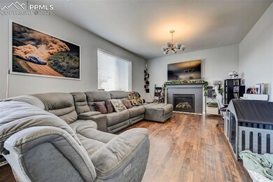 Living room with an inviting chandelier, dark wood
