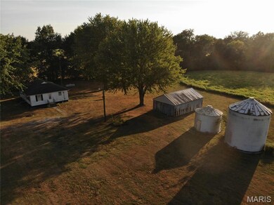 View of green lawn with an outbuilding