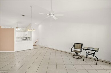 Dining area after furniture removed with ceiling fan and high vaulted ceiling