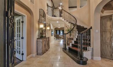 The entry shows off the curved stair case and beautiful overhead lighting