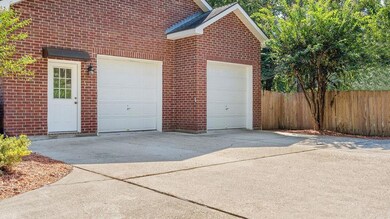 Expansive driveway with double garage and side ent