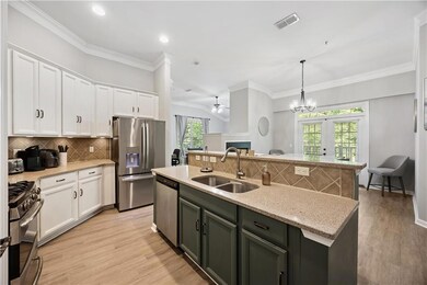 Kitchen featuring appliances with stainless steel finishes, ceiling fan, white cabinets, decorative backsplash, and ornamental molding