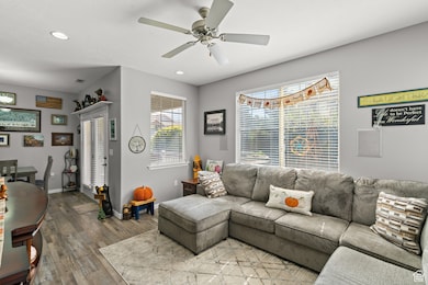 Living room with recessed lighting, hardwood / wood-style floors, and ceiling fan