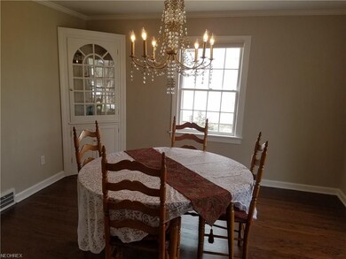 Dinning room offers hardwood flooring, crystal cha