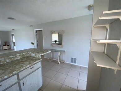 Space efficient kitchen overlooking dining and liv