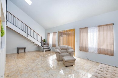 Living area featuring stairs, tile patterned floor