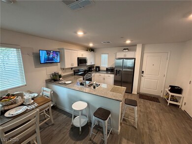 Kitchen with white cabinetry, stainless steel appliances, dark wood-style flooring, a peninsula, and recessed lighting