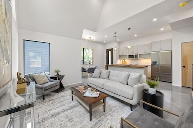 Living room featuring high vaulted ceiling, reces