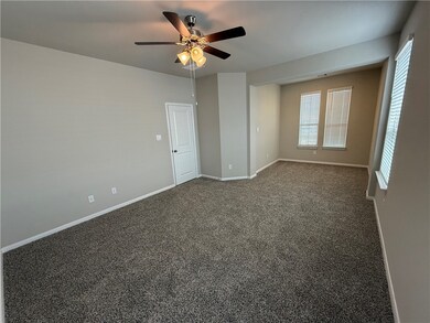 Unfurnished room featuring ceiling fan and dark co