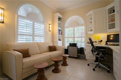 Den has crown molding & plantation shutters