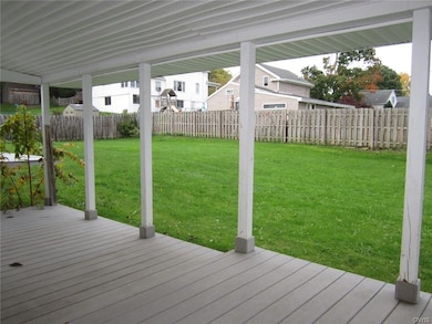 View of backyard from covered porch/deck area.  Th