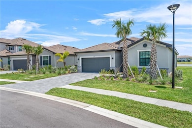 Single story home with stucco siding, a front lawn, a garage, and decorative driveway