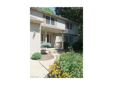 The manicured front walk leads you to the front en