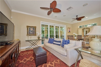 Living area with ornamental molding, french doors, a ceiling fan, recessed lighting, and tile patterned floors