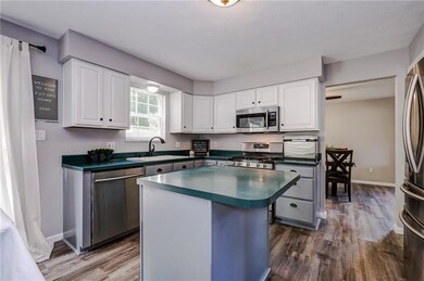 Enjoy the views of the backyard from the kitchen sink, two toned cabinets, SS appliances, gas range, eat-at island, & open to the dining area & family room.