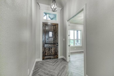 Gorgeous oversized knotty alder front door welcomes you into the Grand Foyer