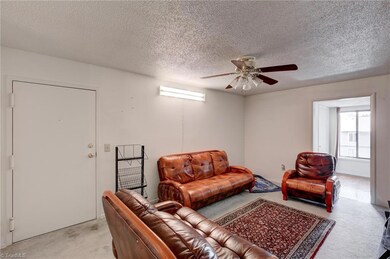 Alternate view of living room and front door.