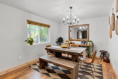 Dining area with light wood-type flooring and a chandelier