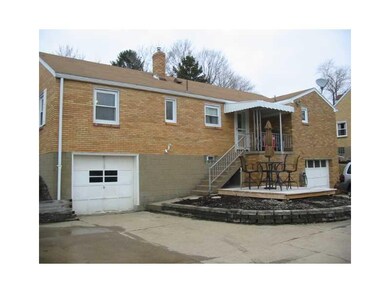 Exterior Back. Two integral garages and patio area