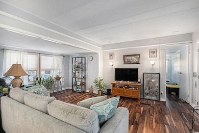 Living room featuring dark wood-style flooring