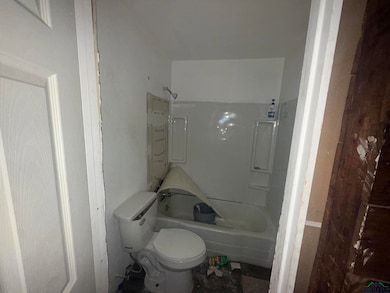 Bathroom featuring tub / shower combination and toilet