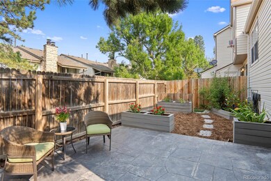 Backyard with stamped concrete, planter beds, and sprinkler system.