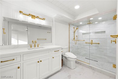 Bathroom with a shower with door, vanity, and toil