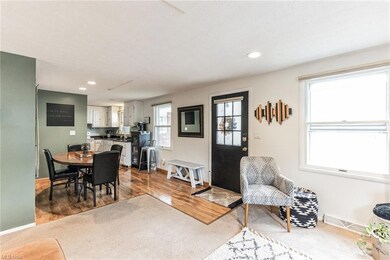 Living room with sink and wood-type flooring