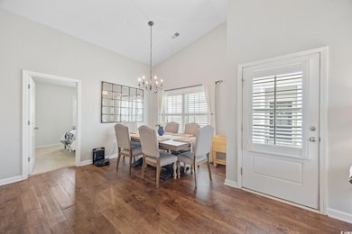 Dining space featuring a chandelier, wood finished