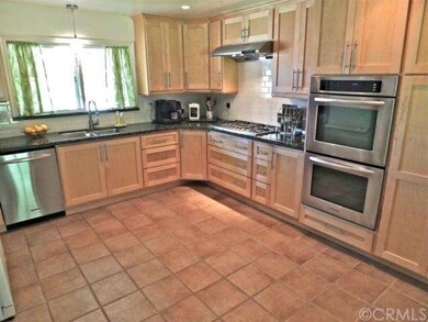 Kitchen cabinets are custom maple shaker, granite counters are verde oceano. The backsplash is subway tile. All built-ins are high end stainless steel.