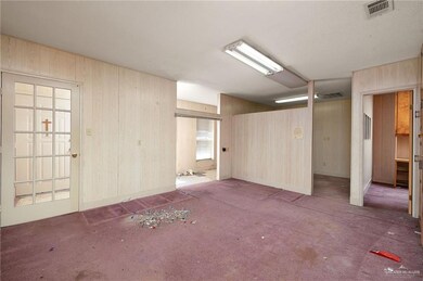 Spare room featuring wood walls