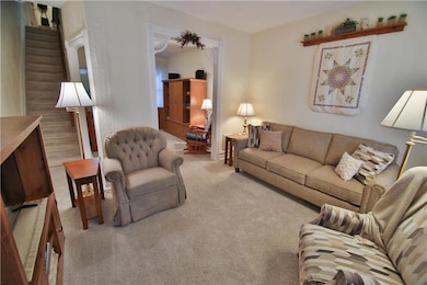 Cozy living room greets you with lots of natural l