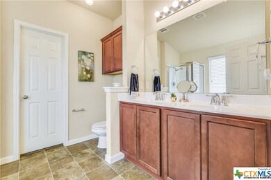 Master bath has double vanity and walk-in closet