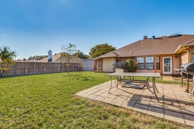 View of yard featuring an outbuilding, a patio are