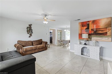Tiled living room featuring a fireplace and ceilin