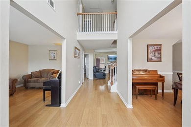 Entrance foyer featuring visible vents, wood finis
