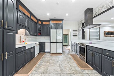 Kitchen featuring white appliances, recessed lighting, island exhaust hood, light countertops, and crown molding
